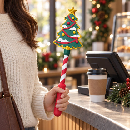 Christmas Tree Tap Wand held at a festive cafe checkout
